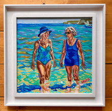 Load image into Gallery viewer, ournemouth Belles by Stella Tooth, an impressionistic oil painting of two women walking in shallow ocean water at a beach framed
