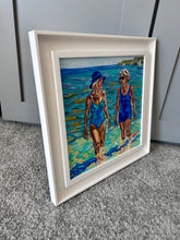 Load image into Gallery viewer, ournemouth Belles by Stella Tooth, an impressionistic oil painting of two women walking in shallow ocean water at a beach side view